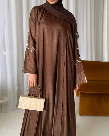 brown abaya set with silver embellishments across the sleeves