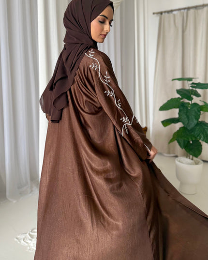 brown abaya set with silver embellishments across the sleeves