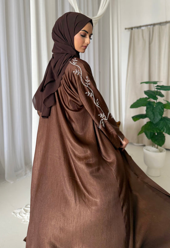 brown abaya set with silver embellishments across the sleeves