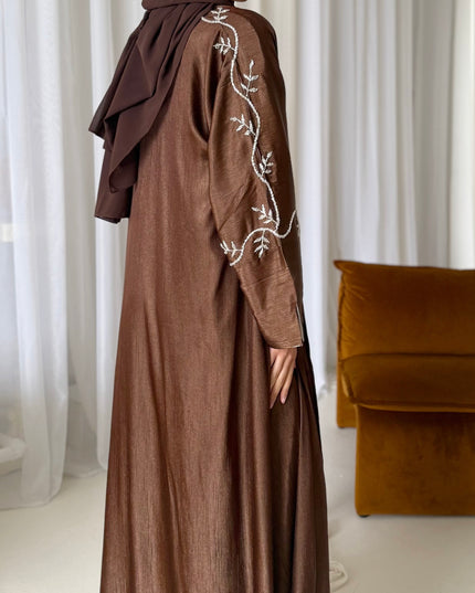 brown abaya set with silver embellishments across the sleeves