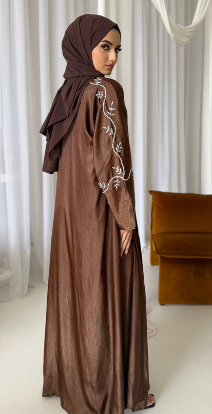 brown abaya set with silver embellishments across the sleeves