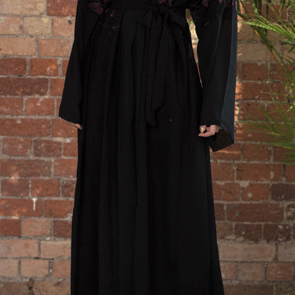 Aaliya Collections A classic black abaya with contrasting burgundy floral embroidery