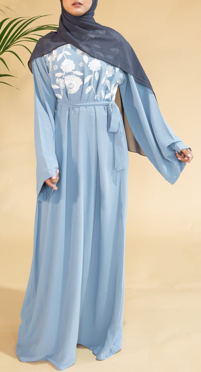 Aaliya Collections Blue Floral Abaya closed abaya of a pastel shade of blue with stunning contrasting white floral finishing