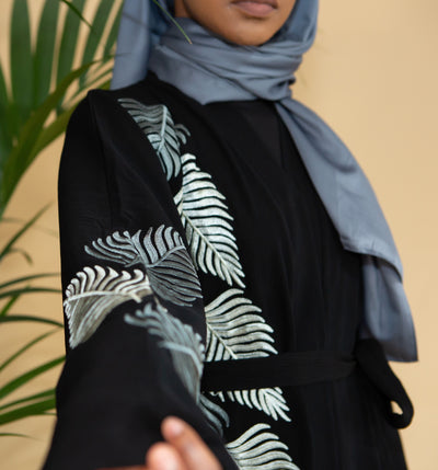 Aaliya Collections Grey Leaf Abaya Created with contrast in mind, a stunning black abaya with gorgeous grey shades in leaf embroidery